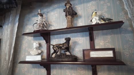 antique figurines on display shelves