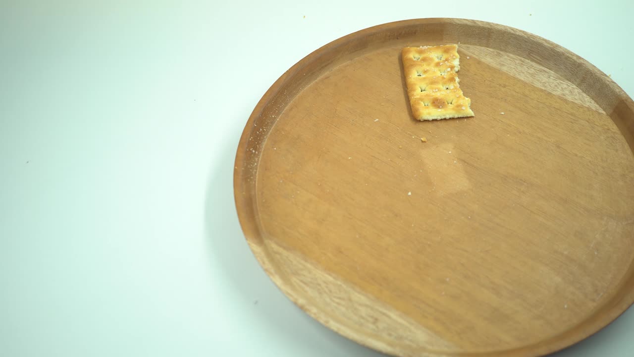 Christmas cracker biscuit over the wooden plate, fork and spoon with white background.