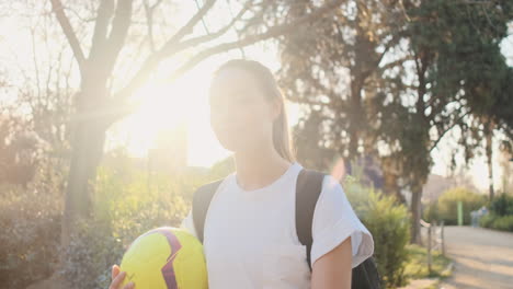 young happy female soccer player going to a training.