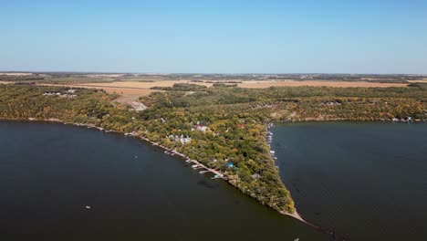 Aerial-Drone-View-of-a-Natural-Cape-Lakeside-Town-Under-Summer-Blue-Sky