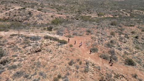 group of people walking through australian desert in exmouth, western australia