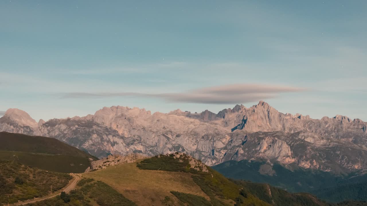 View of Picos de Europa Mountain Range with beautifull full moon light rays during night view from collado de Llesba in Northern Spain, Cantabria.