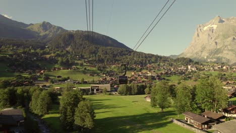 pushing in towards descending cabin of tricable car system eiger express in grindelwald with unique views of grindelwald village and mount wetterhorn