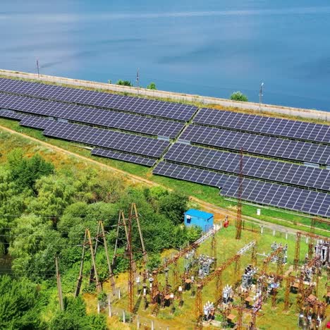 Solar energy farm on sea water background. Blue photovoltaic panels get sunny energy. Renewable source of green eco energy. Aerial view