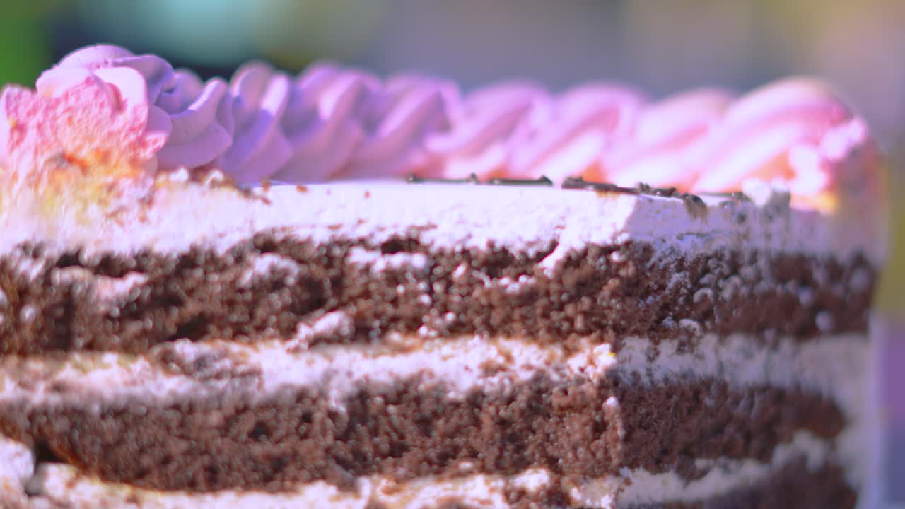 Delicious Sweet Chocolate Cake Dessert with Shallow DOF with Colorful Icing Frosting and Layers of Buttercream.