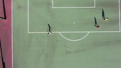 Amateur-Soccer-player-practicing-slalom-movement-with-a-Soccer-ball,-Aerial-view