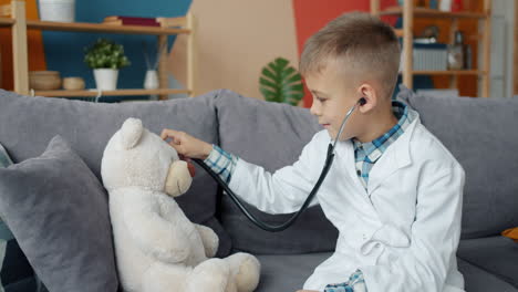 child playing doctor with teddy bear