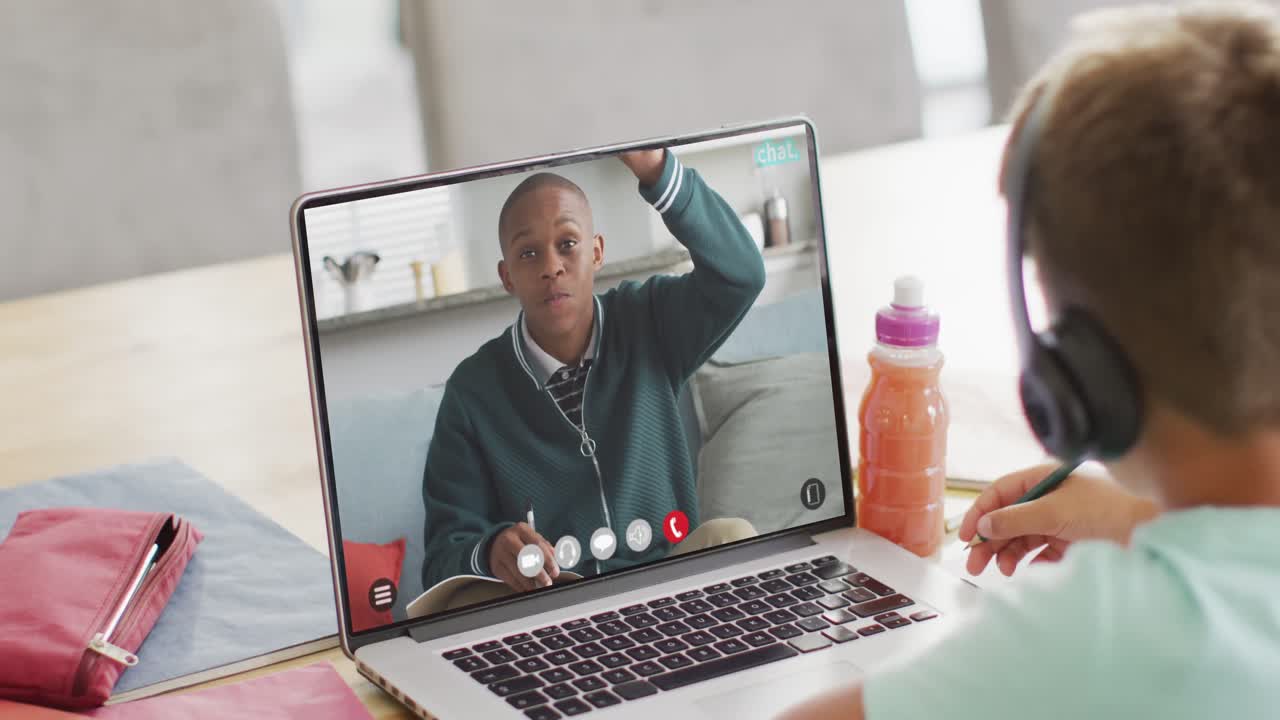 Composition of caucasian boy on laptop online learning with african american schoolboy
