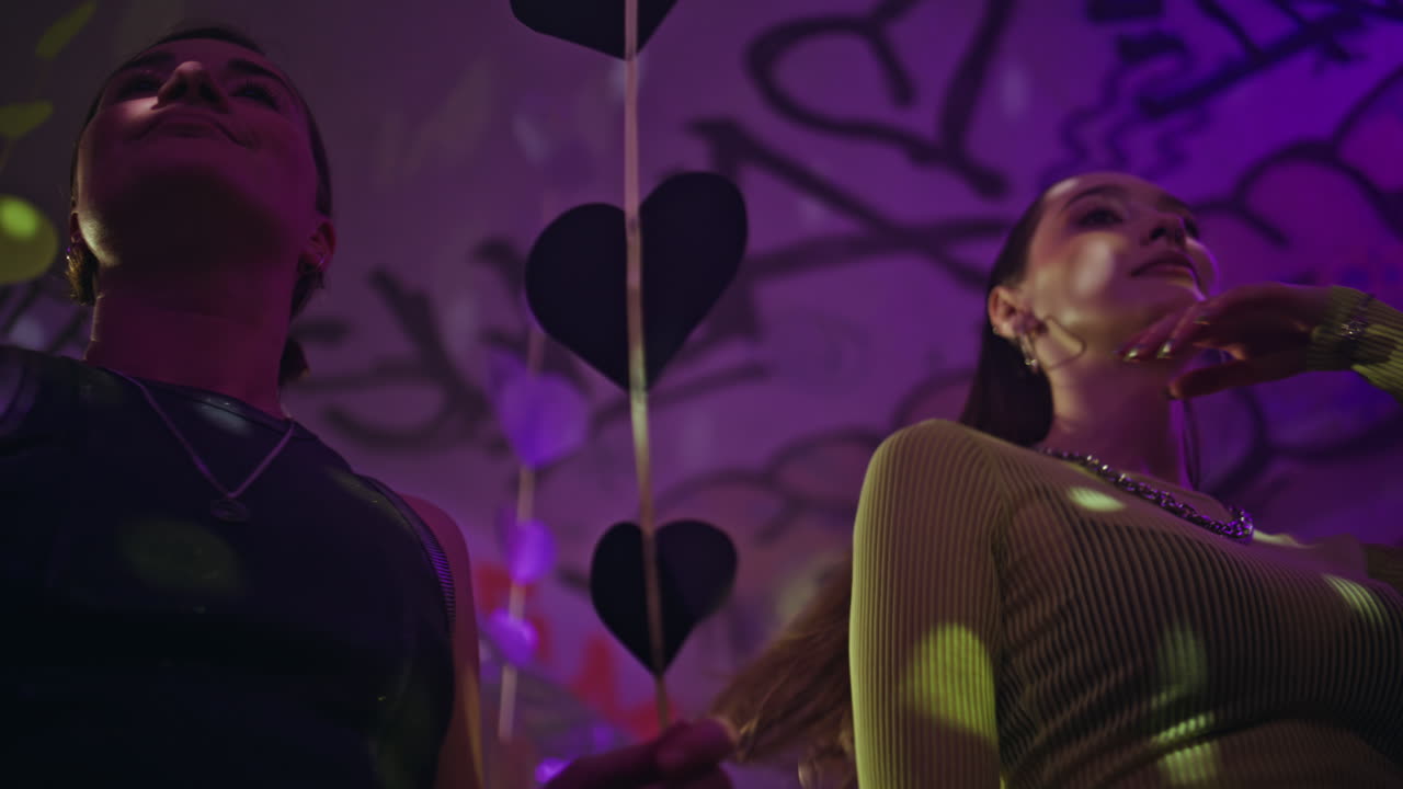 Happy friends clubbing together in nightclub closeup. Happy people dancing party