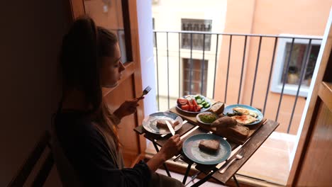 woman enjoying a healthy breakfast with a city view