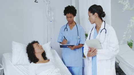 Front-view-of-African-american-female-doctors-doing-routine-check-up-in-ward-at-hospital