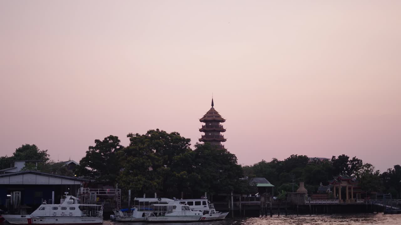 Sunset over the Chao Phraya River with a Pagoda in Bangkok