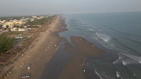 4k drone footage flying smoothly along the beach, following the water’s edge and capturing the gentle waves and sandy shoreline in a scenic coastal view.