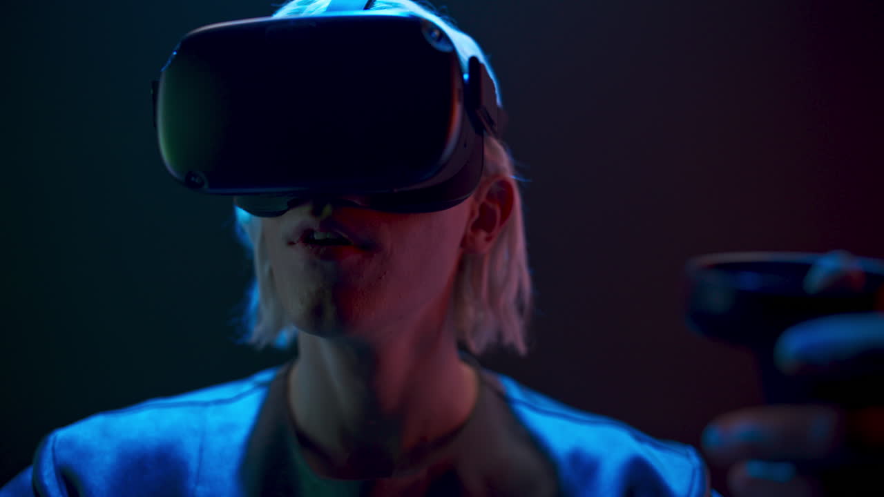 Surprised gamer playing videogame neon light. Man travelling invisible vr world