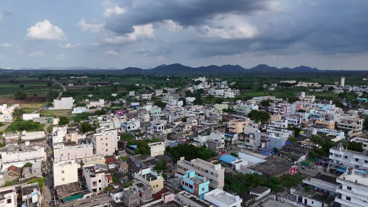 Aerial capture of Vijayawada city, where the green hill creates a striking contrast against the city’s bustling life