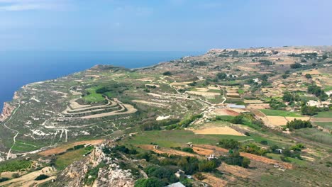 gorgeous aerial drone video from west of malta, dingli area, flying over the steep hills on a sunny day