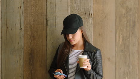 a young student posing in front of a wood wall