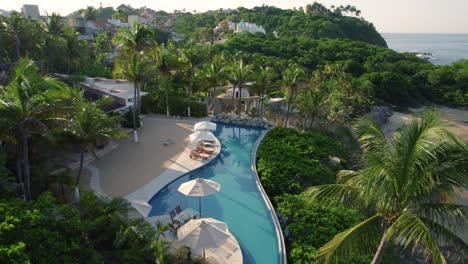 Drone-Aerial-tilt-shot-of-beautiful-vacation-home-with-pool-palm-trees-revealing-gorgeous-landscape-and-hill