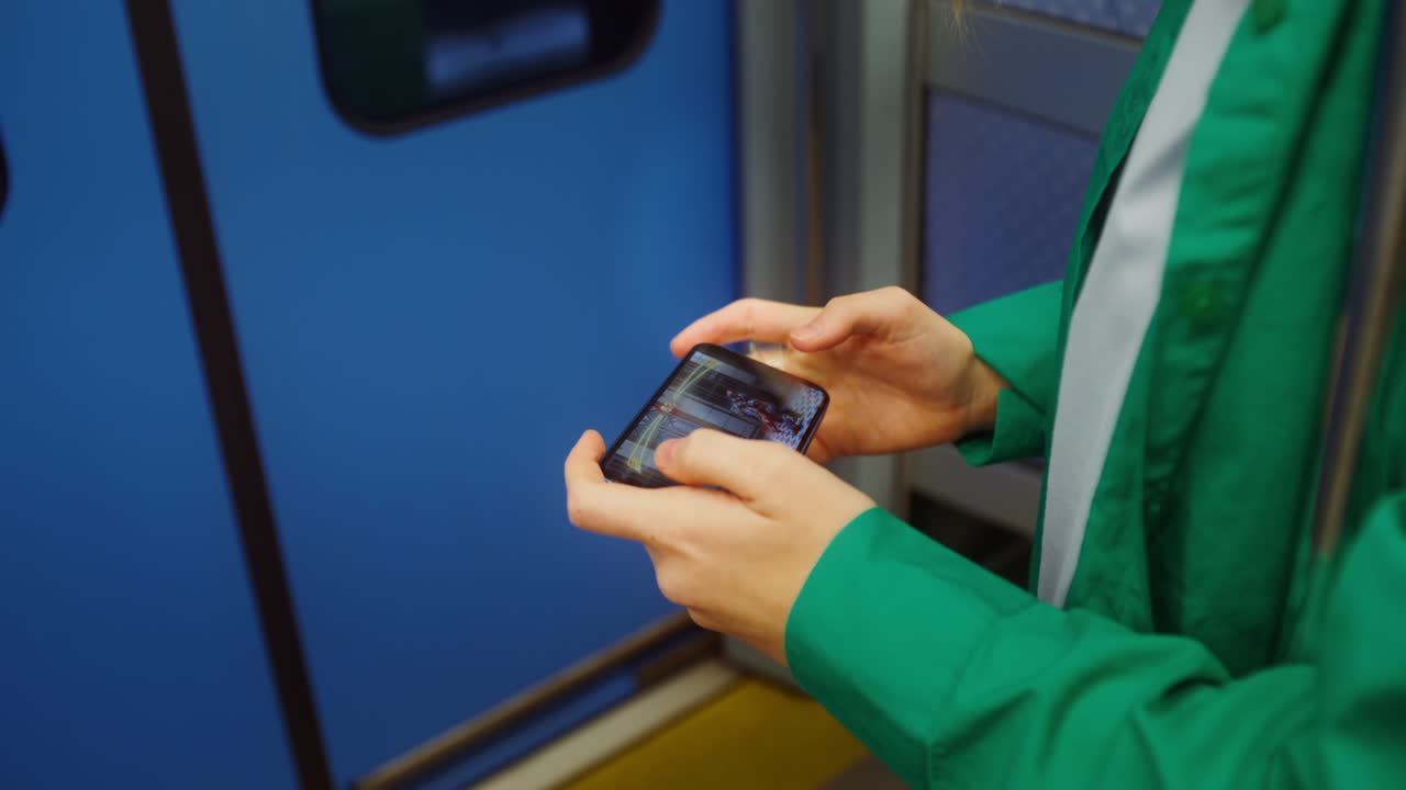 Person using mobile phone on subway train