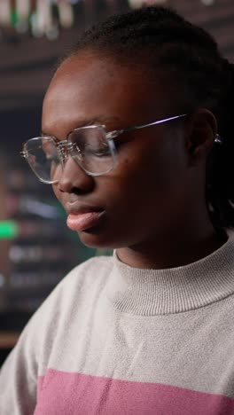 vertical video black girl studying in university library for her bachelor degree diploma