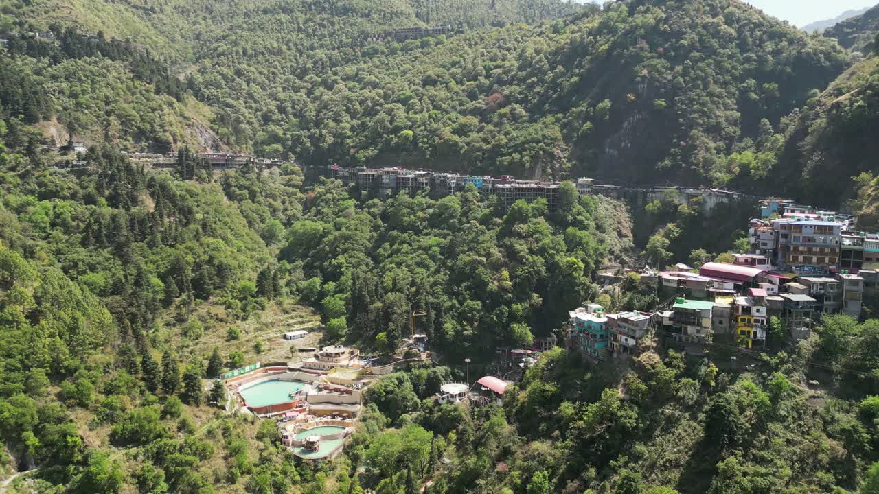 revel empty water falls in greenery hills drone moving wide to closer view in Mussoorie in India