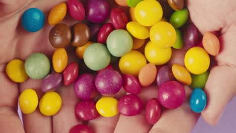 colorful candies in hands