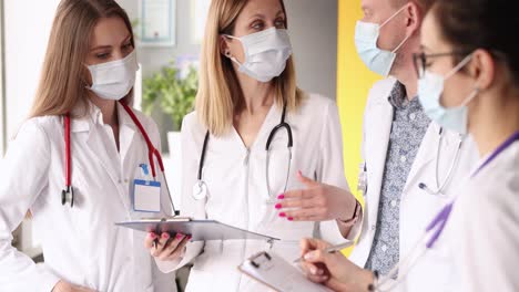 medical professionals collaborating in masks