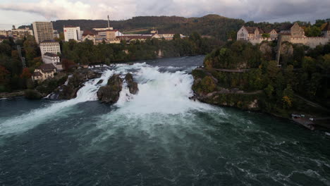 Fantastic-aerial-shot-in-approach-and-in-the-middle-distance-to-the-falls-of-the-Rhine-and-where-the-castle-of-Laufen-can-be-seen