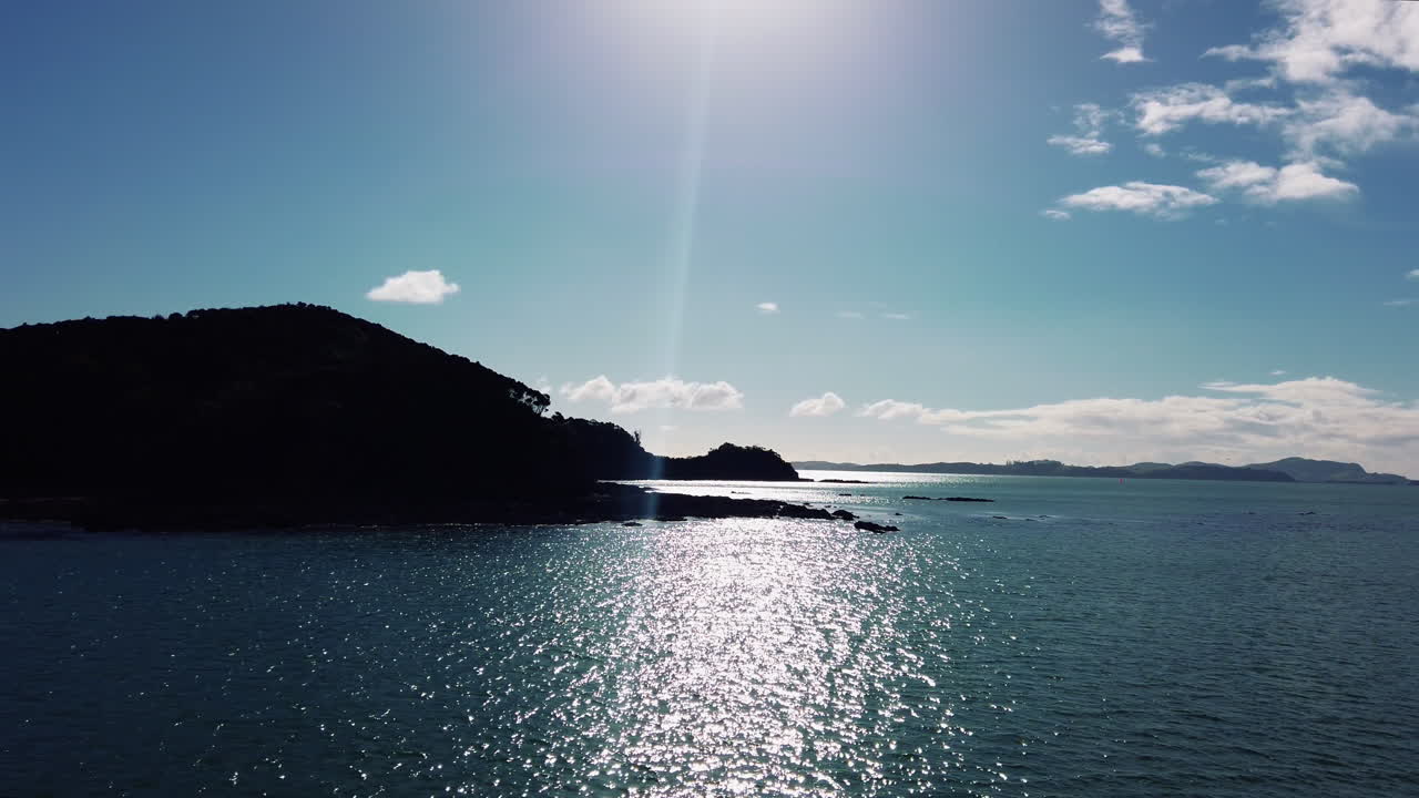 Beautiful Islands On A Sunny Day In New Zealand. Sunlight Reflection On Blue Sea - wide shot, slow motion