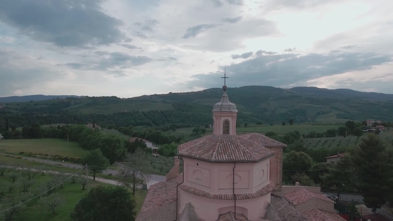 Aerial Drone shot Crane Up behind Church Over Italian Countryside in Umbria, Italy