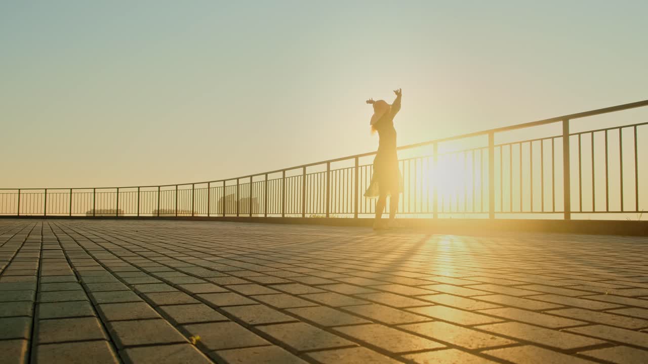 Woman enjoying the sunset on a balcony