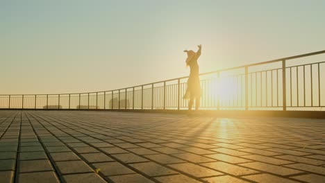Woman enjoying the sunset on a balcony