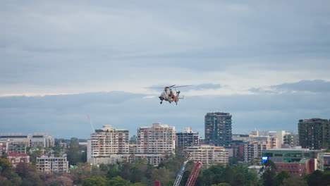 raaf arh military helicopter flying over brisbane city buildings during riverfire, 4k slow motion