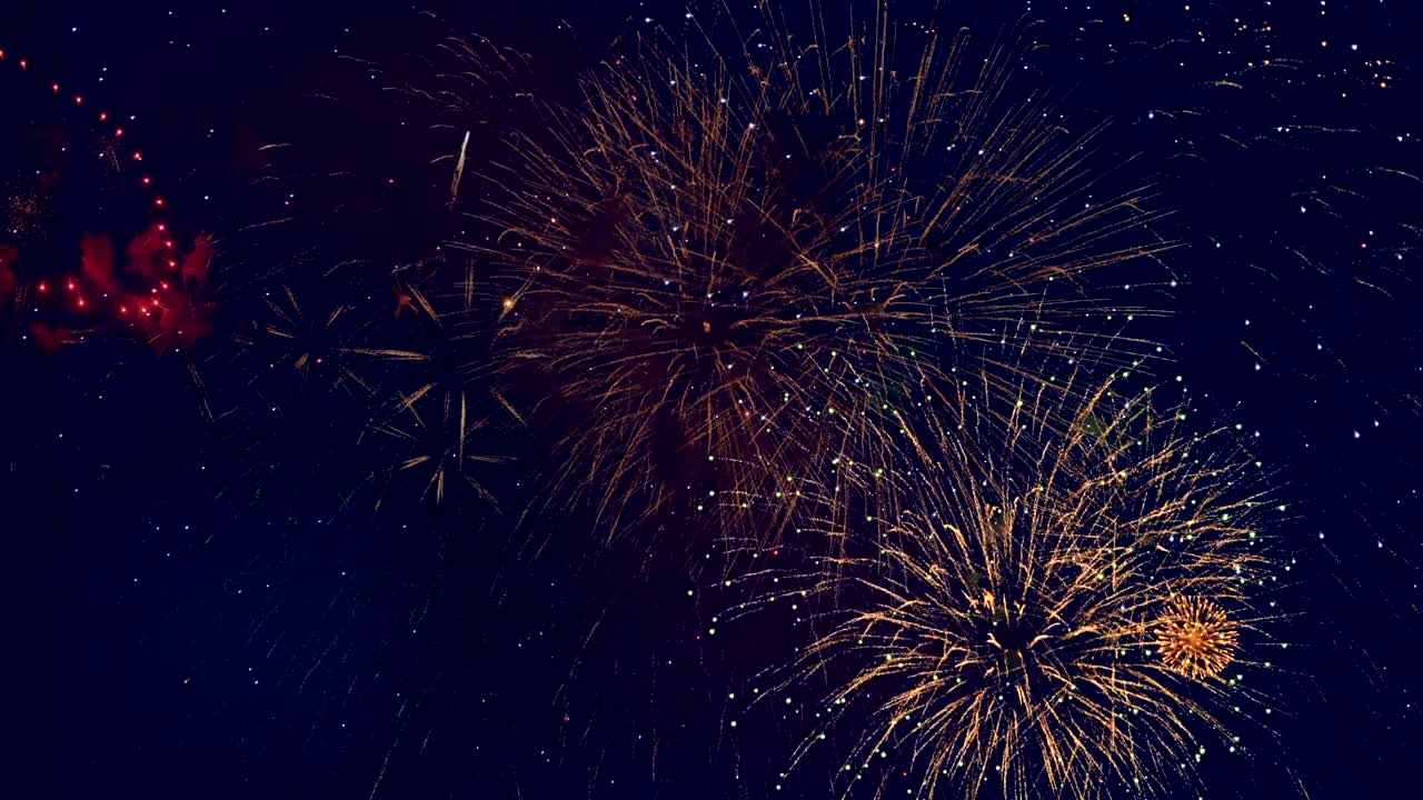 Lots of vivid fireworks glowing in the sky. 4K.