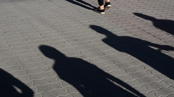 Light and shade, reflection of people in beams of the setting sun. People and shadows from them