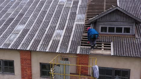 roofer climbs and balances on exposed rafter lookouts, patches roof with caulk