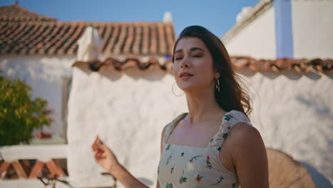 calm lady walking sunbeams mediterranean village closeup. woman exploring town