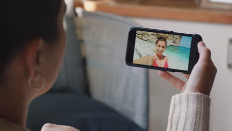 young woman video chatting using smartphone happy friend on vacation beach in italy sharing travel experience having fun on holiday communicating with mobile phone