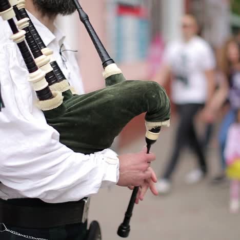 street performer playing his bagpipes
