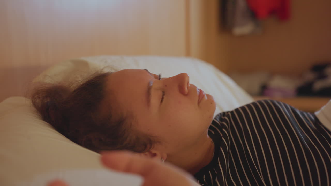 Rofuld kvinde starter dagen blidt. Fredfyldt kvinde vågner gradvist og strækker sig i hyggelige hotelomgivelser. Rolig og fredelig kvinde står fredfyldt op og forbereder sig på dagen i et komfortabelt hotelværelse