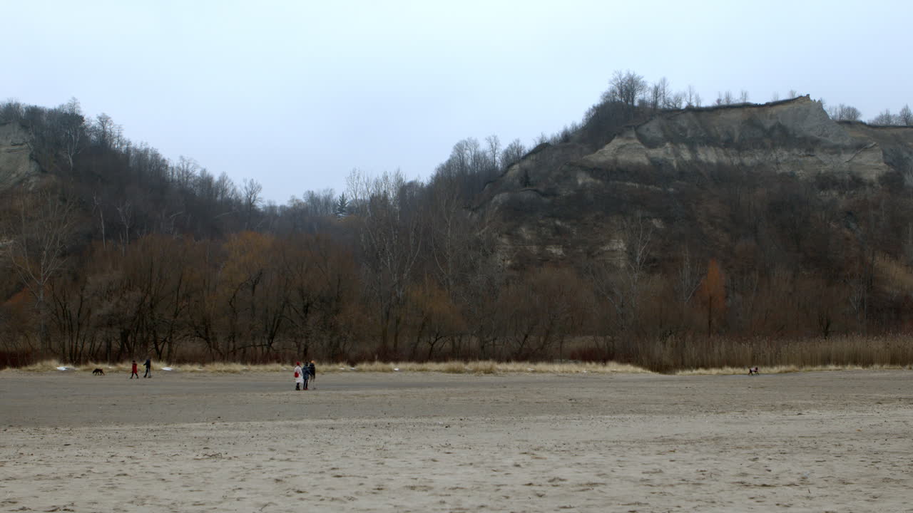 People enjoying overcast Christmas day at the beach at Scarborough Bluffs, Toronto, Canada