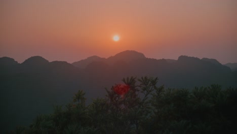 sunset glow behind cat ba mountain silhouettes