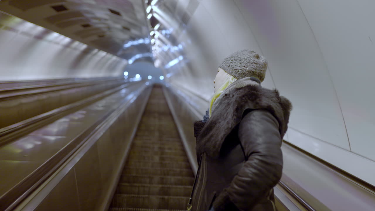Woman on escalator in the metro