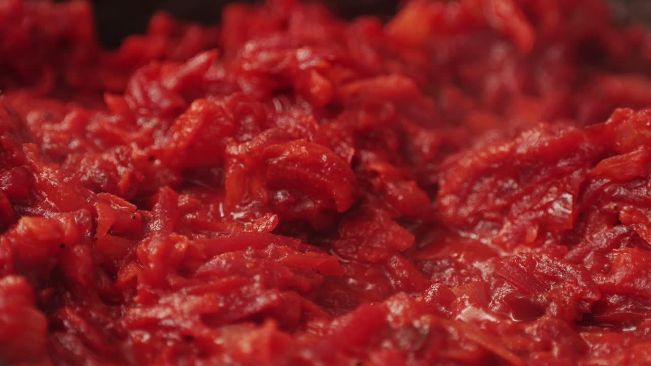 Cooking traditional national Russian, Ukranian soup Borsch close-up. Boiling red soup with vegetables and turkey meat and spices. Special red for Borsh from beet, carrot and tomatoes pasta