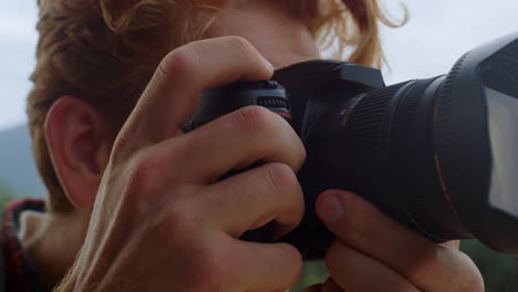 Closeup-photographer-hands-take-picture-on-photo-camera.-Tourist-film-nature.