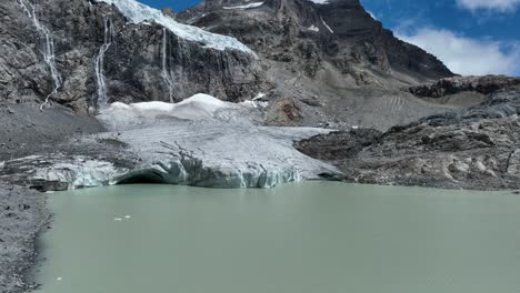 aerial panning right reveal drone shot of fellaria's oriental lake and glacier - valmalenco - sondrio