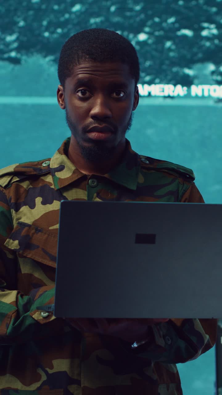 Soldier in Camouflage Uniform Using Laptop in Control Room