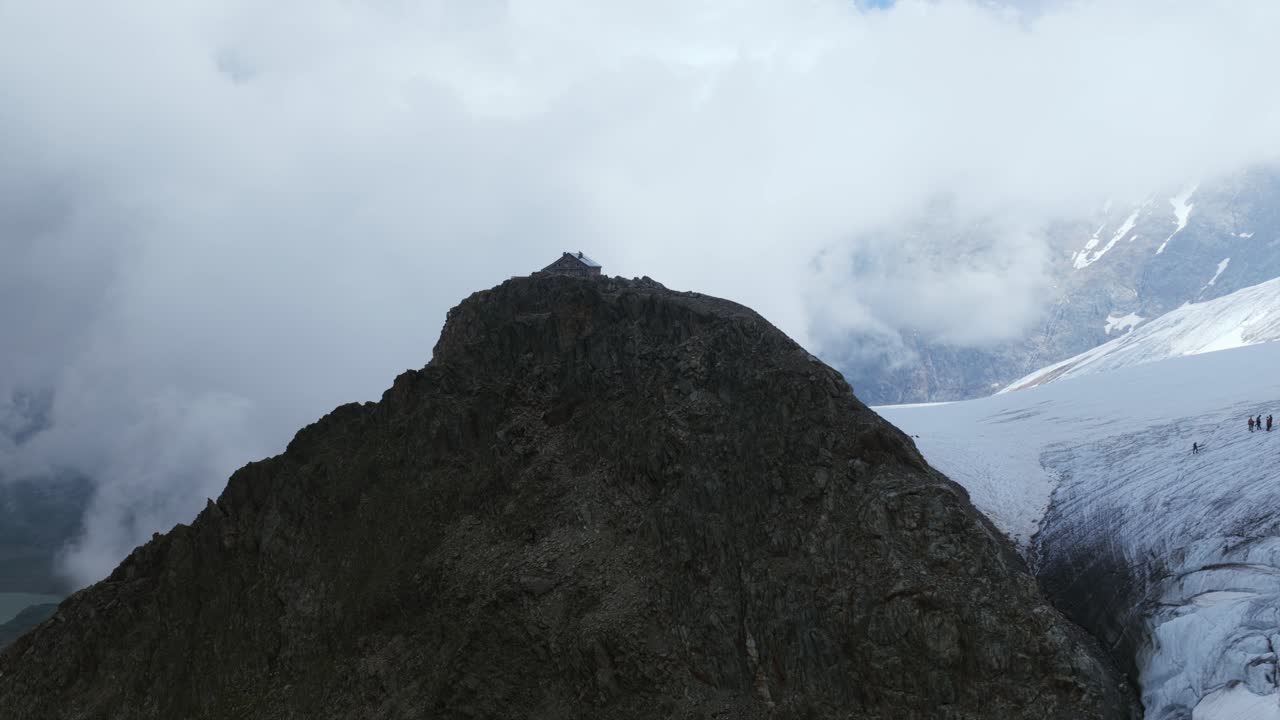 Winter mountain dramatic aerial landscape, hikers on glacier, Sustenpass, Switzerland