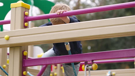 boy on playground equipment