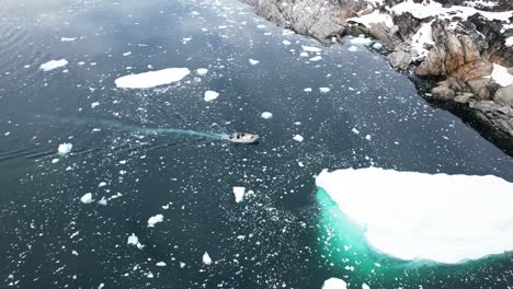 expedition vessel in freezing ocean of greenland, aerial view
